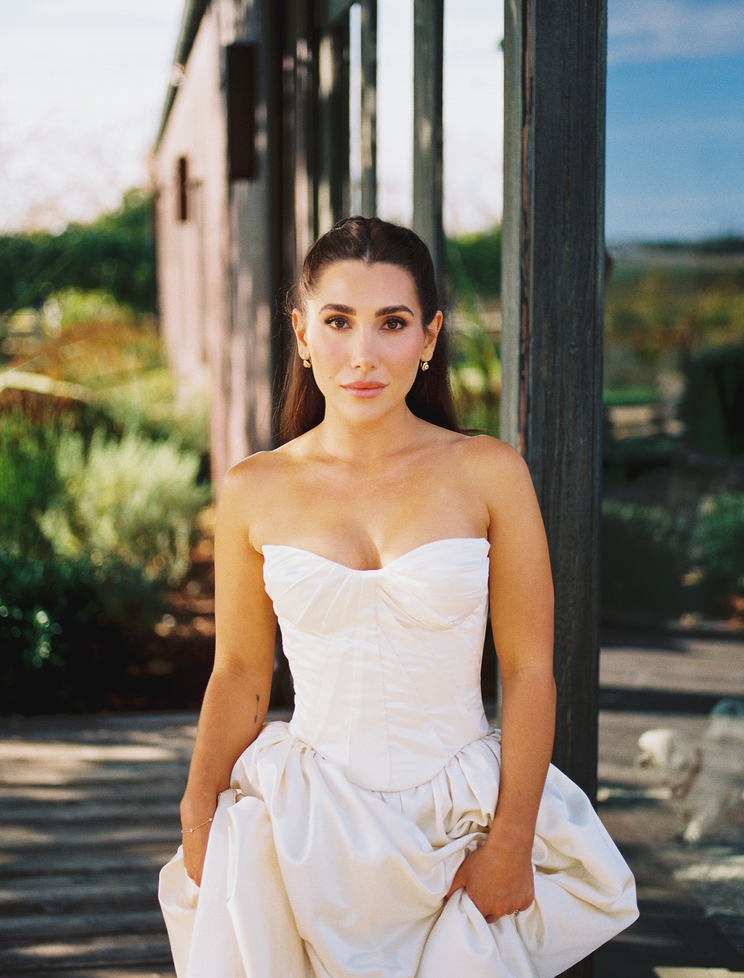 A bride in a corseted gown at golden hour on the Cavalli grounds