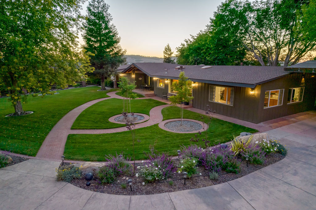Aerial view of the Ranchhouse & Suites and its landscaped gardens at golden hour
