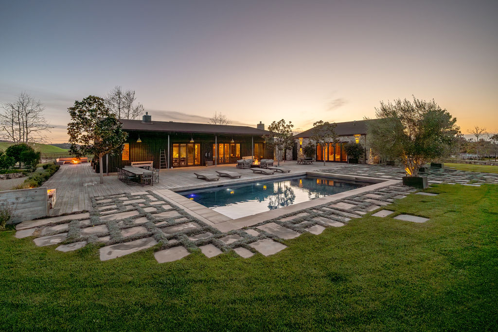 Vineyard House exterior, view 1 of the grounds, pool, decks, and vineyards