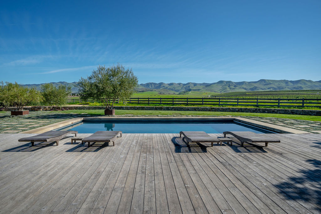 Vineyard House exterior, view 3 of the grounds, pool, decks, and vineyards