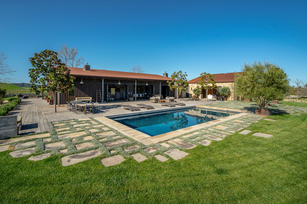 Vineyard House exterior, view 5 of the grounds, pool, decks, and vineyards