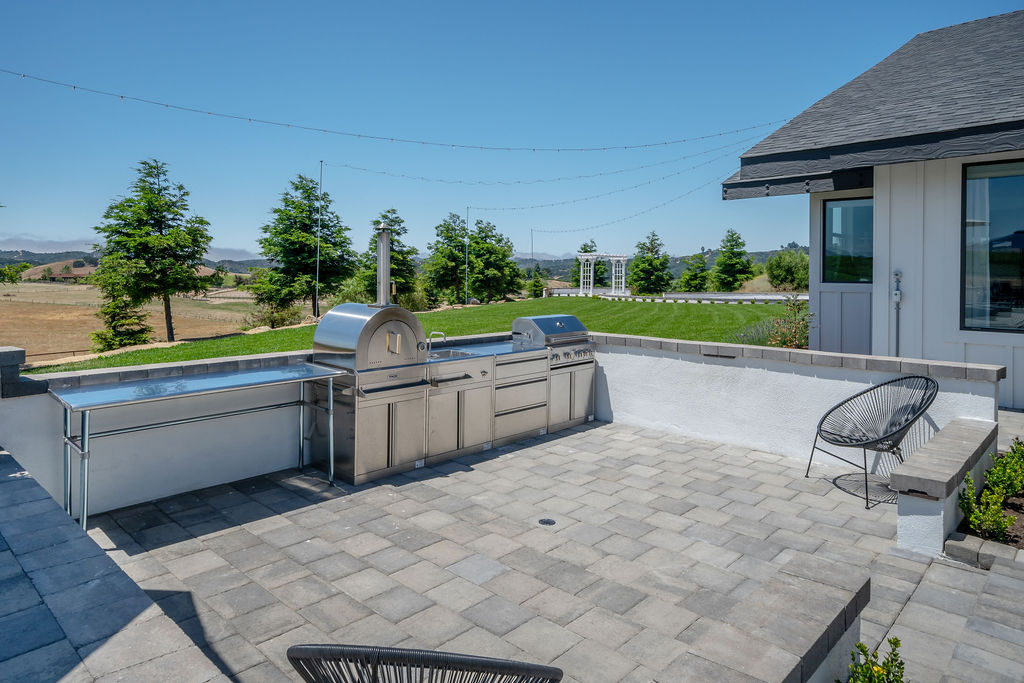 The Villa's pool terrace, sunken fire lounge, and cabana above the Edna Valley vineyards