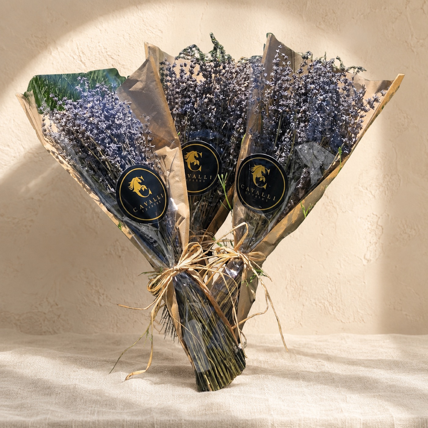 Three kraft-wrapped Cavalli dried lavender bouquets tied with raffia