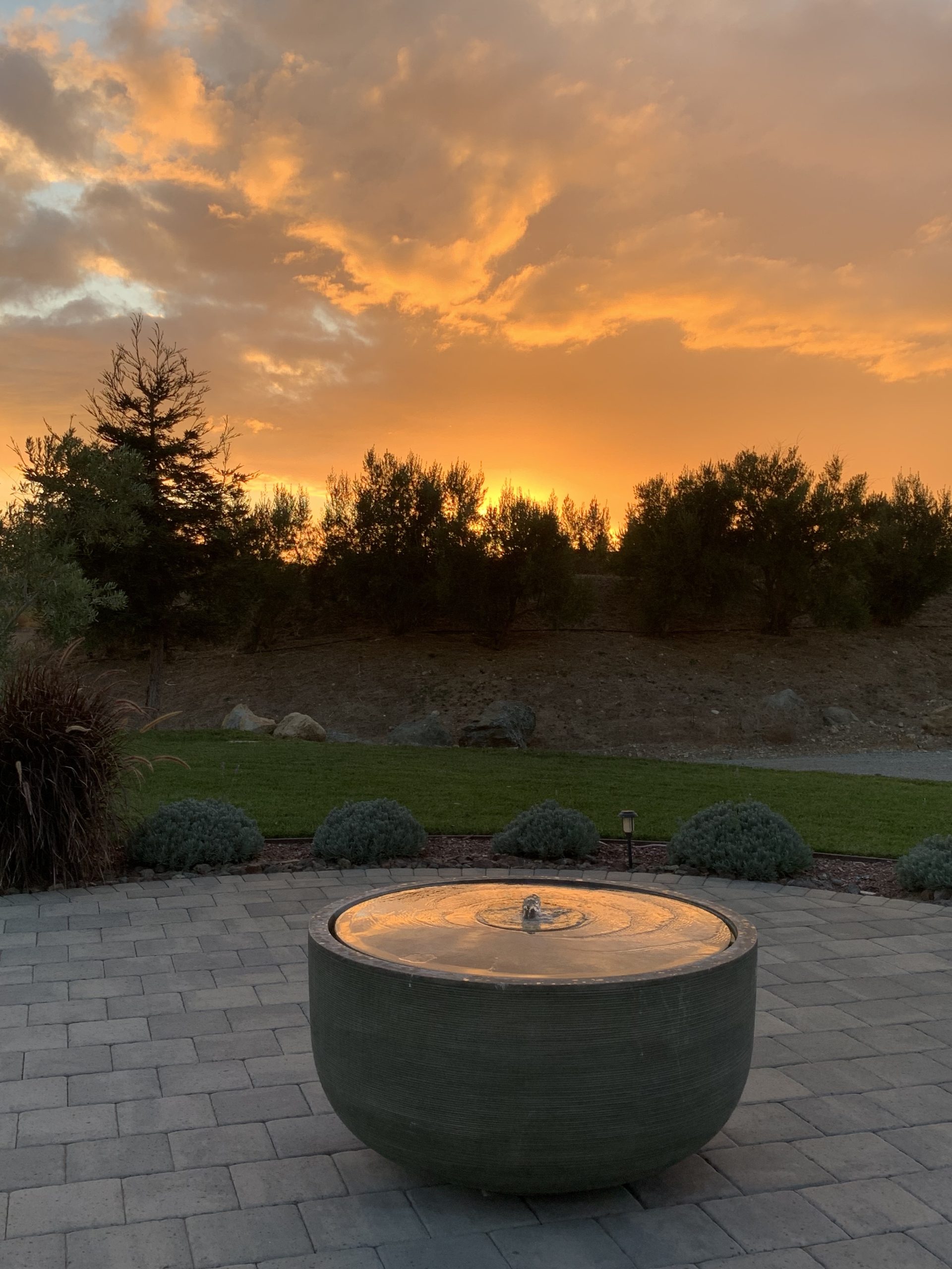 The Villa's courtyard fountain silhouetted against a golden Edna Valley sunset